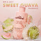 mCaffeine Guava Tini De-Tan Body Wash 300 ml - sweet guava fragrance visual with the bottle in a water splash beside fresh guavas
