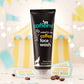 mCaffeine Coffee Face Wash 100 ml - coffee with white water lily - black tube on a yellow carnival backdrop with coffee beans