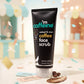 mCaffeine Coffee Face Scrub 100 g - coffee with vitamin E - black tube on a pastel carnival backdrop with coffee beans
