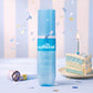 mCaffeine High Shine Perfector Hair Spray 100 ml - 31% shine complex - blue spray bottle on a festive backdrop with cake and confetti