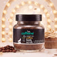 mCaffeine Naked and Raw Coffee Body Scrub 100 g - coffee with coconut - glass jar with coffee beans on a lit festive backdrop